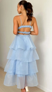 Detailed back view of light blue organza tiered dress showing open back and lace-up design