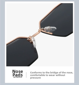 Detail of rose gold metal nose pads and bridge on rimless polygonal sunglasses