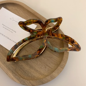 Detail of tortoise shell acetate butterfly hair claw clip with teal marbling effect