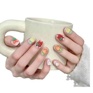 Handmade press-on nails featuring 3D fruit designs like strawberries on shimmery base