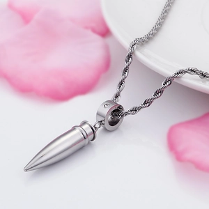 Macro shot of silver bullet pendant with twisted rope chain in street style fashion