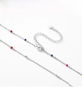 Detail of S925 sterling silver chain with colorful beads and heart-shaped pendant charm
