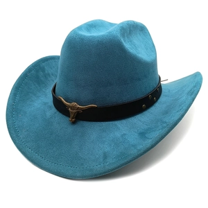 Detail of peacock blue suede cowboy hat with vintage bronze bull head metal emblem