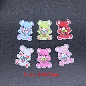Flat lay of colorful 15x20mm resin hug me bears for DIY phone cases and hair accessories