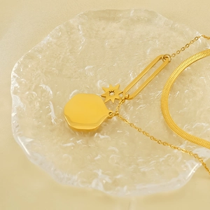 Double layered gold stainless steel necklace featuring star and circular plate charms