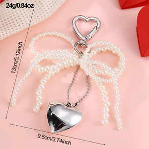 Detail view of pearl bow heart keychain with exact dimensions 13cm length and 9.5cm width