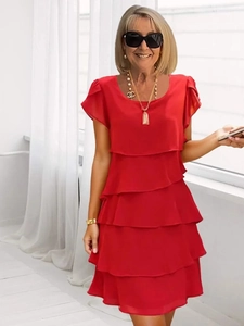 Detail of red tiered ruffle summer dress with short sleeves and a classic crew neck