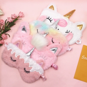 Set of four plush unicorn sleep masks in colorful rainbow faux fur for travel