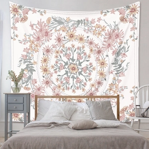 Detail of pink floral mandala tapestry hanging as a bohemian bedroom wall decor