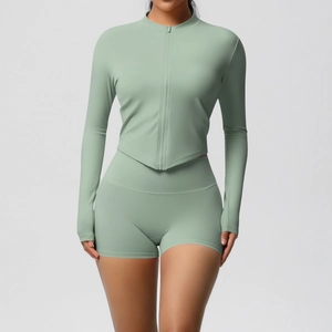 Detail of light green yoga set showing zip-up long sleeve top and high waist shorts
