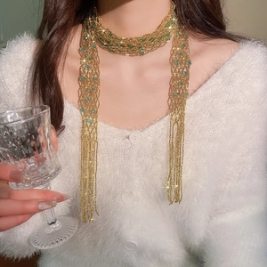 Elegant crystal beaded fringe scarf necklace detailed view on model wearing white sweater