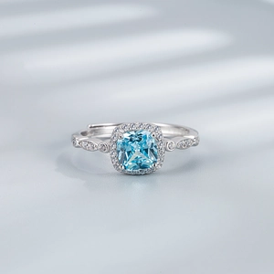 Macro detail of a 925 silver ring featuring a square blue stone and halo diamonds