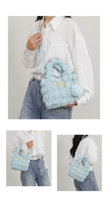 Three-angle view of a blue plush cloud bag with a golden bow and fur ball charm