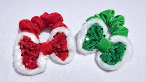 Detail of red and green velvet hair scrunchie with sequins and plush white fur trim