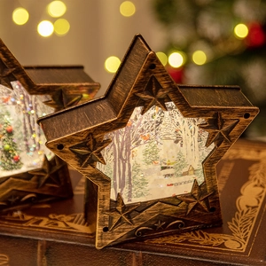 Lanterne boule de neige de Noël en étoile bronze vintage avec lumière LED et décor hivernal.