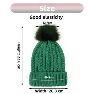 Dark green knitted hat with faux fur pom and size dimensions showing height and elastic width