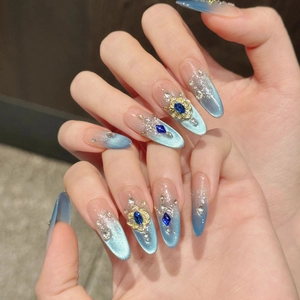 Luxury blue cat-eye press-on nails with royal diamonds and gold floral accents
