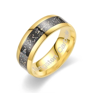 Macro shot of gold tungsten carbide ring with black starry inlay and inner engraving