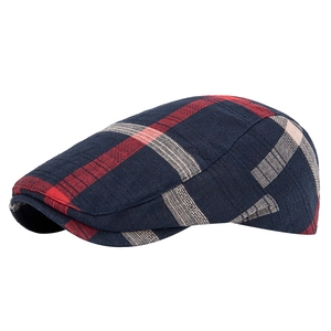 Classic blue and red plaid ivy cap with woven texture on a white background