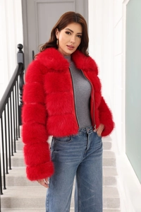 Close-up of bright red faux fur jacket featuring soft texture and premium zipper detail
