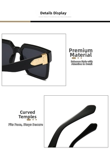 Close-up of black oversized sunglasses with gold metal M detail and curved temples