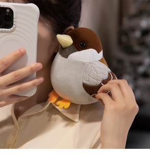 Cute plush sparrow doll on a model's shoulder showing soft texture and bird details