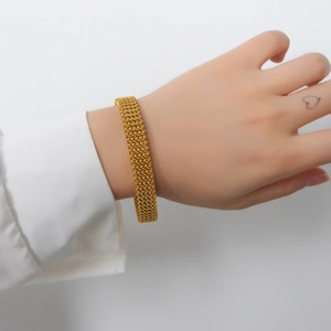 18K gold plated stainless steel mesh woven cuff bracelet for couples on a model wrist