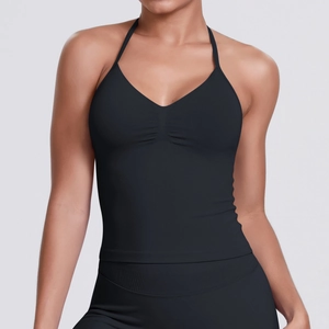 Detail of black halter neck sports bra with ruched V-neckline for fitness and yoga