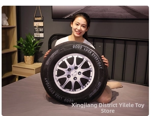 Detail of creative 3D car tire plush pillow with Good Luck Everyday printed on the side