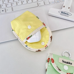 Detail of grid fabric earphone pouch with snap button and bear pattern accent
