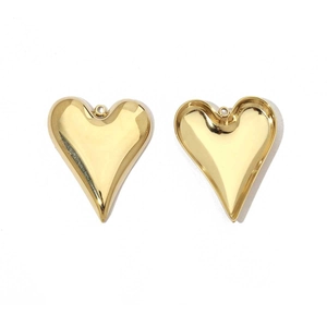 Detailed macro view of two golden heart-shaped stainless steel pendant charms