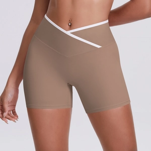 Detail view of coffee-colored yoga shorts with crossover high waistband and white trim