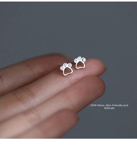 Close-up of S999 sterling silver cat paw stud earrings with sparkling zircon stones