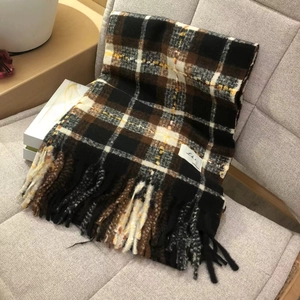 Classic houndstooth scarf in black, brown, and yellow with elegant fringe detail