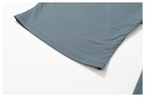Detailed close-up of grey-blue yoga top hem with durable double-stitch seams