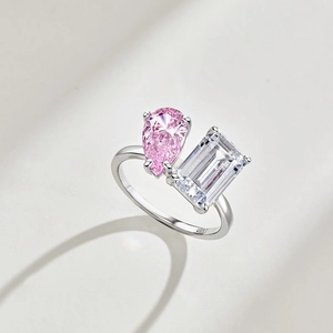 Detailed view of S925 silver ring with pink pear and clear emerald cut zircon stones.