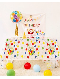 Colorful birthday party set featuring balloons, banner and festive disposable tablecloth