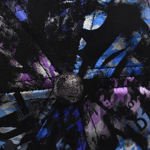 Macro shot of colorful tie-dye patterns and textured metal prints on baseball cap crown