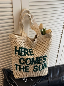 Straw tote bag with HERE COMES THE SUN green embroidery and woven beach texture