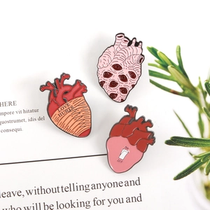 Creative anatomical heart enamel pins set with Love Hurts and On-Off toggle designs