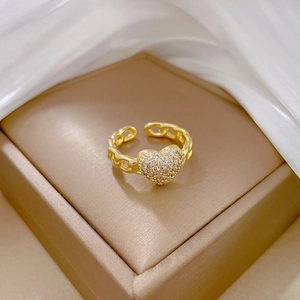 Gold plated open heart ring with white zircon pave and chain band in a velvet box