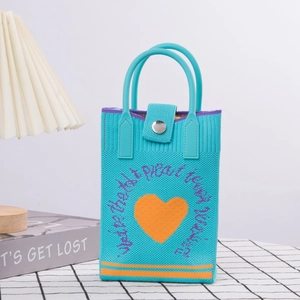 Detail of blue knitted phone bag with orange heart and soft blue rubber handle