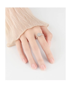 Detail of silver clover ring with micro-set zircons shown on a female finger