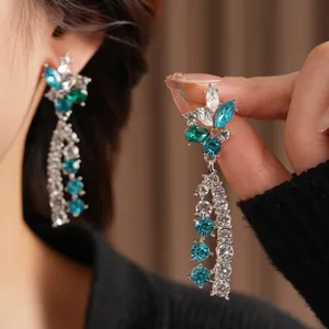 Vintage floral jewelry set with blue and emerald crystals and silver tassel design