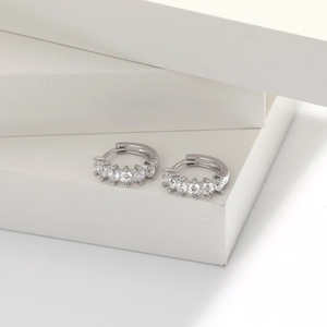 Detail view of silver S925 earrings with white zircon pavé setting on a white display