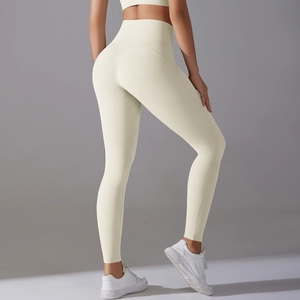 Detailed side view of high-waisted beige yoga pants showing seamless texture and fit