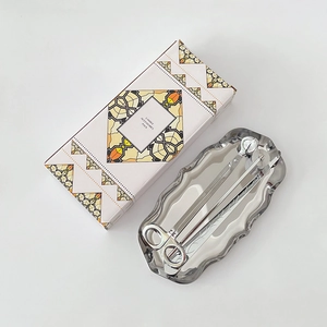 Silver stainless steel candle accessory kit with trimmer, snuffer, and tray in box