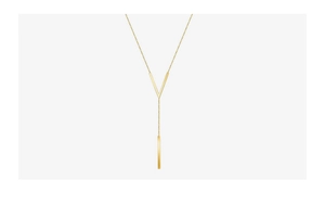 Macro shot of gold V-shaped necklace with long bar pendant and polished metallic texture