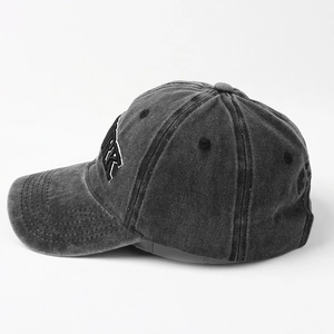 Side view of dark grey washed denim baseball cap with York embroidery and curved brim
