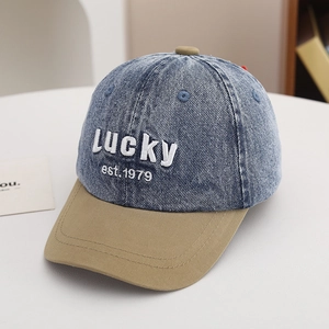 Detail of vintage washed denim baseball cap with Lucky embroidery and khaki brim